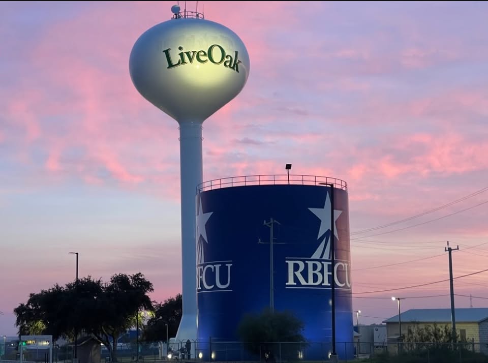 Live Oak water tower against a pink sunset sky