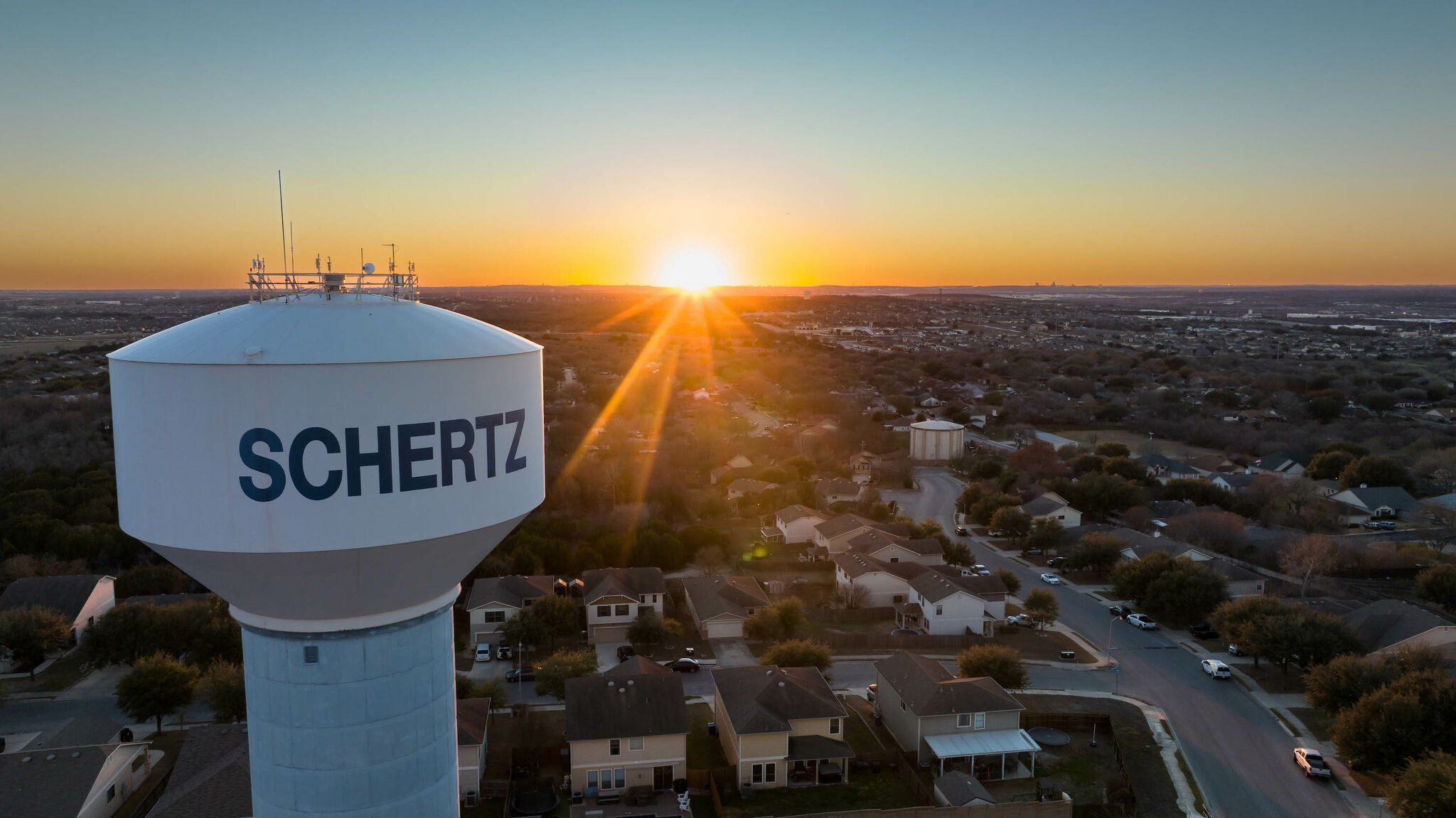 Schertz water tower overlooking the neighborhood at sunset