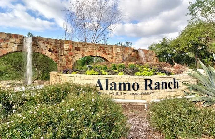 Alamo Ranch entrance sign with stone arches, waterfalls, and landscaped gardens