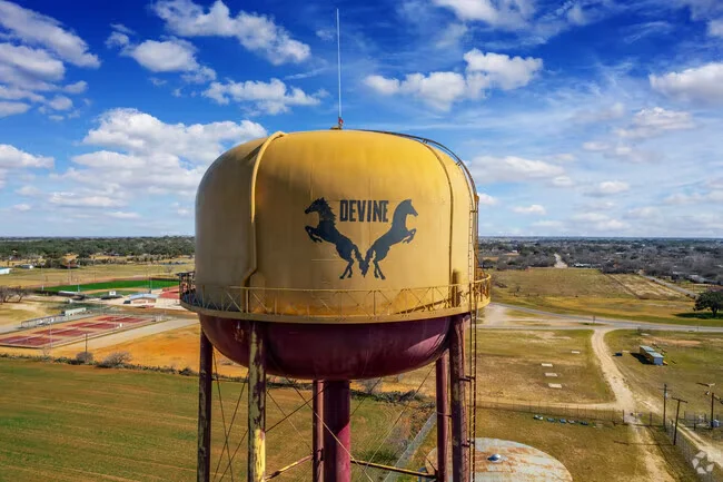 Devine water tower with horse silhouettes overlooking the surrounding community