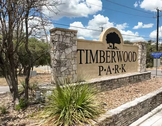 Timberwood Park entrance sign with stone pillars and landscaped grounds
